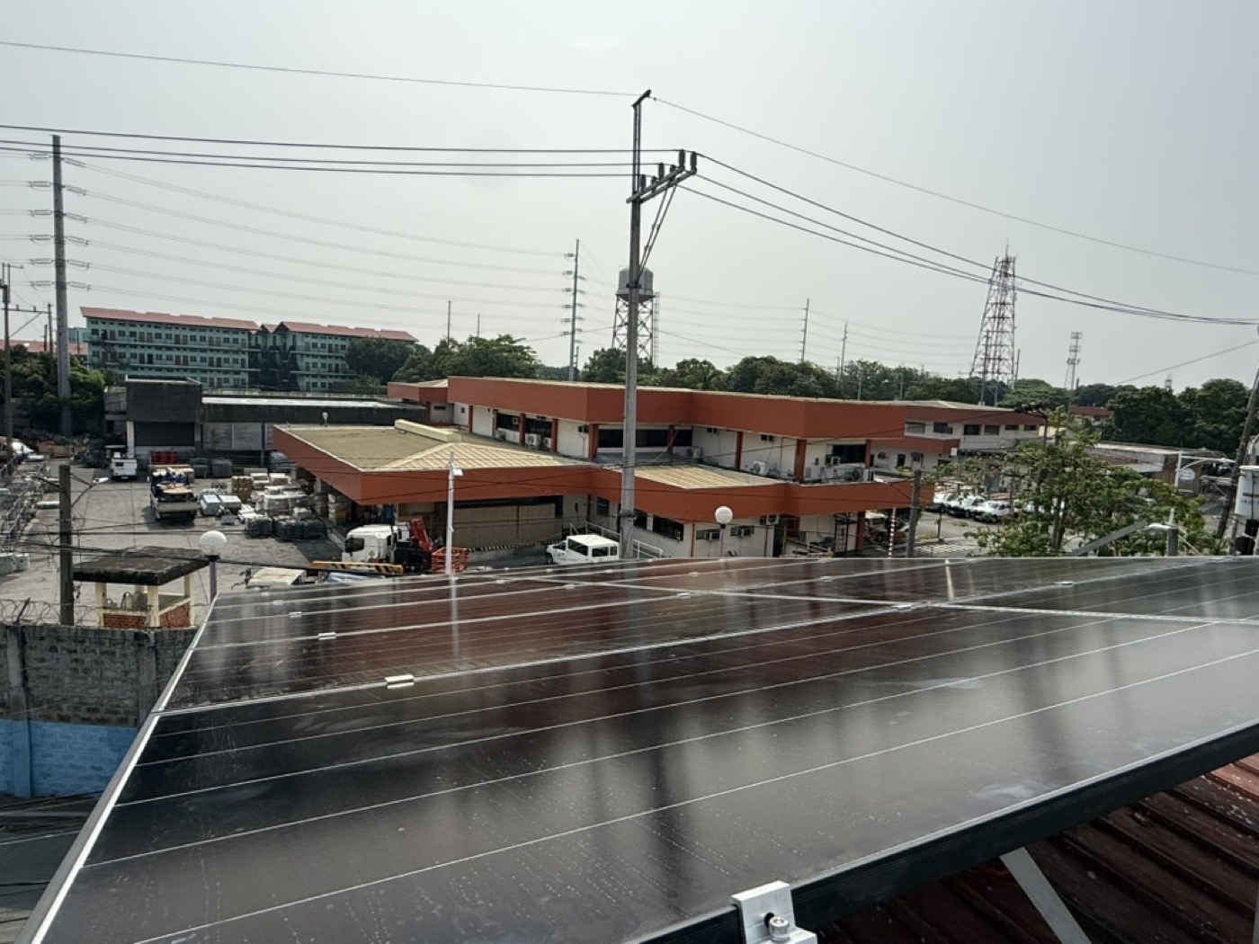 Commercial rooftop solar installation overlooking a roadside business district