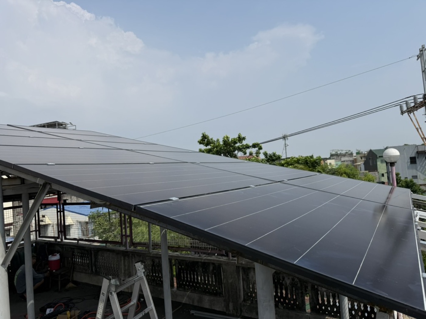 Large rooftop solar array seen end on, showing the number of panels in a full installation